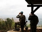 Israeli soldiers take a position along the Israel-Lebanon border on March 7, 2026. (AFP)