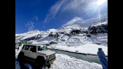 A vehicle parked at a snow-covered area near the North Portal of Atal Tunnel, Lahaul and Spiti, on Sunday. (PTI)