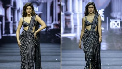 Shanaya Kapoor walked for Ritika Mirchandani at Lakme Fashion Week (LFW) 2026. She was dressed in an ensemble from the designer’s ‘Confluence’ collection, featuring a hand-embroidered, pre-draped saree in a deep charcoal hue, with intricate geometric beadwork and sequin embellishments that create a shimmering, liquid effect. It is paired with a matching corset-style bralette blouse with a plunging neckline and delicate straps. The look features minimal jewellery with rings and statement earrings. (@lakmefashionwk/Instagram) Shanaya Kapoor walked for Ritika Mirchandani at Lakme Fashion Week (LFW) 2026. She was dressed in an ensemble from the designer’s ‘Confluence’ collection, featuring a hand-embroidered, pre-draped saree in a deep charcoal hue, with intricate geometric beadwork and sequin embellishments that create a shimmering, liquid effect. It is paired with a matching corset-style bralette blouse with a plunging neckline and delicate straps. The look features minimal jewellery with rings and statement earrings. (@lakmefashionwk/Instagram)