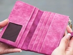 Chic two-fold wallets in fresh colours and textures sit ready to organise cards, cash, and tiny essentials inside your handbag.(pexels.com)