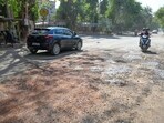 Commuters report accidents on pothole-ridden road. Repeated patchwork fails; MCG says revamp and recarpeting planned before monsoon. (Parveen Kumar/HT)