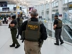 Immigration and Customs Enforcement (ICE) agents patrol at John F. Kennedy International Airport, New York City
