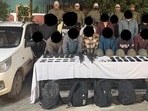 Security forces with the arrested militants, and the seized arms and ammunition. (HT Photo) Security forces with the arrested militants, and the seized arms and ammunition. (HT Photo)