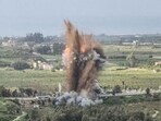 A fireball rises from the site of an Israeli airstrike that targeted the Qasmiyeh bridge, located on a main highway linking villages in the Tyre district with others further north, after Israel said the bridge was being used by Hezbollah, in southern Lebanon, on March 22, 2026. 