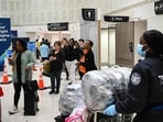 Amid a TSA staffing crisis due to unpaid workers, Trump orders ICE agents to assist at major airports. However, there is no definitive list released as of yet. (Photo by RONALDO SCHEMIDT / AFP)