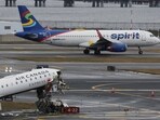 A Spirit Airlines aircraft next to the wreckage of an Air Canada Express jet that collided with a fire truck at New York's LaGuardia Airport in Queens, New York.