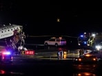 Emergency crews work around an Air Canada Express jet that had collided with a ground vehicle at LaGuardia Airport in Queens, New York.