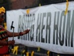 TUCSON, ARIZONA - MARCH 01: A live streamer makes a video as she visits a makeshift memorial for Nancy Guthrie in front of the KVOA television station on March 01, 2026 in Tucson, Arizona. (Photo by JUSTIN SULLIVAN / GETTY IMAGES NORTH AMERICA / Getty Images via AFP)