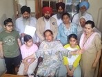 Upinder Kaur, wife of late Punjab State Warehousing Corporation (PSWC) district manager Gagandeep Singh Randhawa, addresses a press conference along with her children and family members at their residence.in, Amritsar, on Sunday, March 22,2026. (Sameer Sehgal/HT)