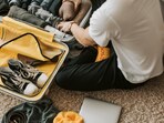 Roomy cabin suitcase opened neatly on the floor, clothes stacked in tidy sections, ready for a quick weekend flight today.(Pexels)