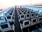 Looking down the aisle at the main cabin and Comfort Plus sections of Delta's Airbus A330neo plane.