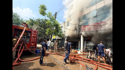 Firemen battling the blaze at a showroom in Industrial Area, Phase 2, Chandigarh. (Ravi Kumar/HT)