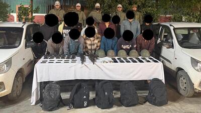 Security forces with the arrested militants, and the seized arms and ammunition. (HT Photo) Security forces with the arrested militants, and the seized arms and ammunition. (HT Photo)