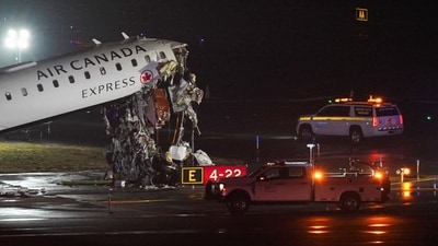 Investigators inspect the wreckage of a fire truck after it collided with an Air Canada Express jet that was landing at LaGuardia Airport in Queens. (REUTERS)