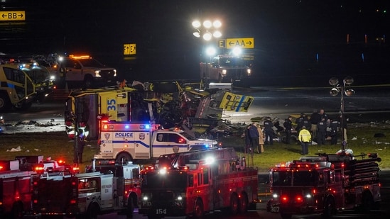 A Port Authority aircraft rescue and firefighting vehicle lays on its side off of runway 4 after Air Canada plane crash.(AP)