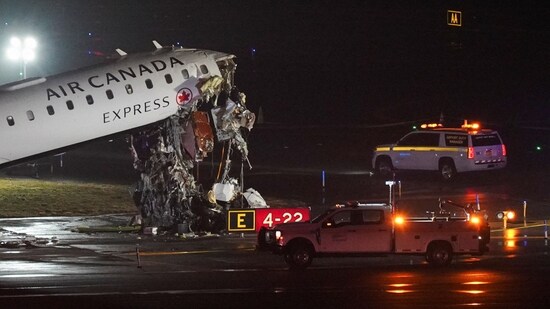 Investigators inspect the wreckage of a fire truck after it collided with an Air Canada Express jet that was landing at LaGuardia Airport in Queens.(REUTERS)