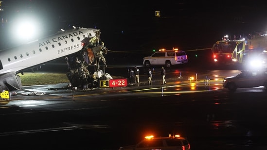 An Air Canada Express plane sits on the tarmac after it collided with a fire truck on the tarmac at LaGuardia Airport (Getty Images via AFP)