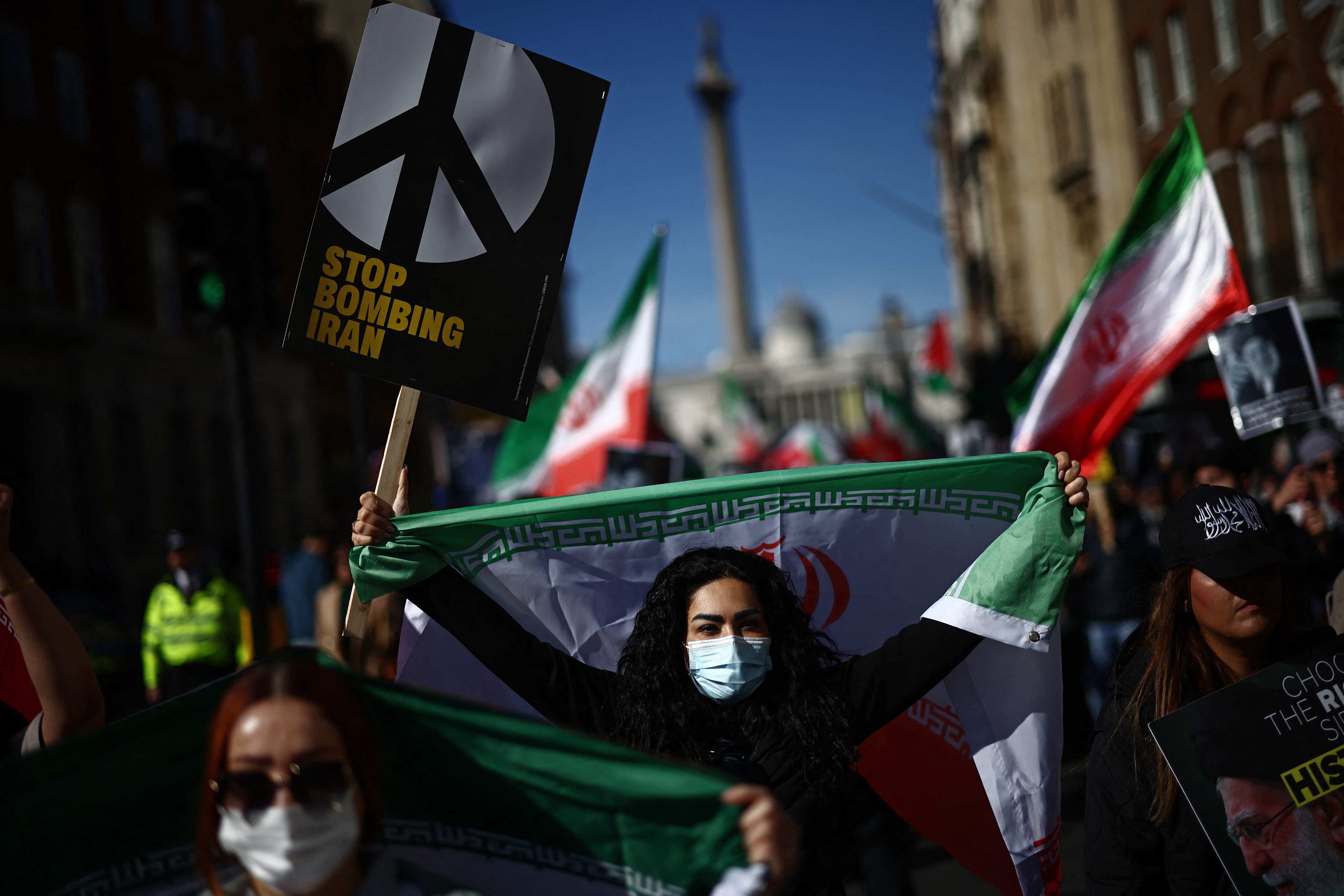 Protesters carry placards and wave Iranian flags on Whitehall during of a protest march in central London on March 21, 2026., calling for the bombing of Iran to stop. (AFP) Protesters carry placards and wave Iranian flags on Whitehall during of a protest march in central London on March 21, 2026., calling for the bombing of Iran to stop. (AFP)