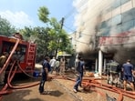 Firemen battling the blaze at a showroom in Industrial Area, Phase 2, Chandigarh. (Ravi Kumar/HT)