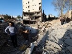 A man stands in the middle of the rubble left of a building that was destroyed by a strike, amid the U.S.-Israeli conflict with Iran, in Tehran, Iran.