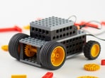 Colourful Lego sets stacked high, offering hours of fun and creativity for kids this summer.