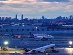 A plane takes off behind the wreckage of an Air Canada jet and Port Authority fire truck that collided at LaGuardia Airport, March 23, in New York. A plane takes off behind the wreckage of an Air Canada jet and Port Authority fire truck that collided at LaGuardia Airport, March 23, in New York.