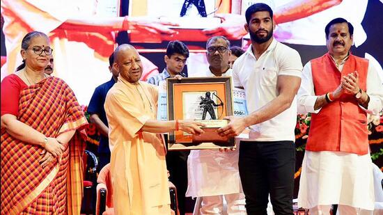 Chief minister Yogi Adityanath doing the honours at a ceremony in Lok Bhawan on Tuesday. (Sourced)