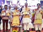 Chief minister Yogi Adityanath with deputy CM Keshav Prasad Maurya and others during the launch of the upgraded single-window investment portal Nivesh Mitra 3.0, in Lucknow, on Tuesday (PTI)