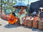 Ranchi: Women sit on empty LPG cylinders as they wait in a queue outside a gas agency to avail the refilled ones amid ongoing supply disruptions.