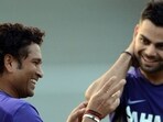 Sachin Tendulkar and Virat Kohli have a chat while representing India in 2013.