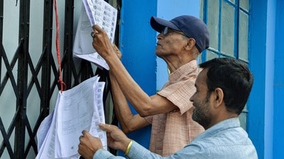 Siliguri, Mar 02 (ANI): Voters check their names in the updated voter list hanging up at the Siliguri Indoor Stadium premises, in Siliguri on Monday. (@drmohanoffice51 X/ANI Photo) (Diptendu Dutta) Siliguri, Mar 02 (ANI): Voters check their names in the updated voter list hanging up at the Siliguri Indoor Stadium premises, in Siliguri on Monday. (@drmohanoffice51 X/ANI Photo) (Diptendu Dutta)