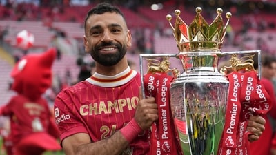 Mohamed Salah poses with the winner's trophy after the English Premier League soccer match between Liverpool and Crystal Palace. (AP)