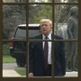 US President Donald Trump stands outside the Palm Room doors at the White House in Washington, DC on March 25, 2026. (Photo by Oliver Contreras / AFP)