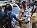 Mumbai, India - Dec. 13, 2024: Traffic Police using personal mobile to E Challan on bikers at Bombay High Court, in Mumbai, India, on Friday, December 13, 2024. (Photo by Anshuman Poyrekar/ Hindustan Times) (Hindustan Times)