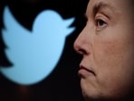 Twitter logo and a photo of Elon Musk are displayed through magnifier in this illustration.