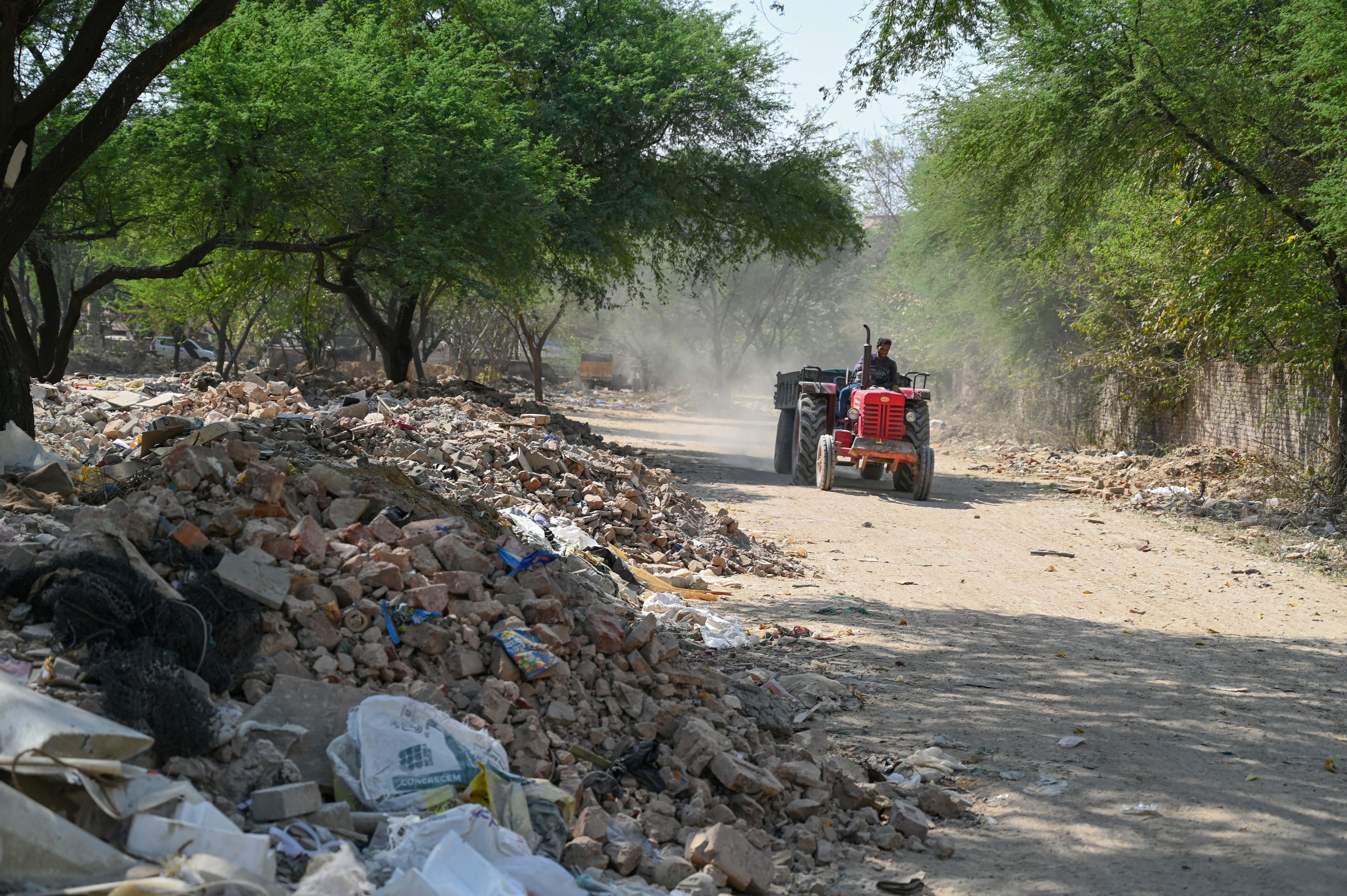Tractors use dirt tracks to unload debris deep inside; activists cite lack of guards, failed enforcement and unchecked violations. (Parveen Kumar/HT) Tractors use dirt tracks to unload debris deep inside; activists cite lack of guards, failed enforcement and unchecked violations. (Parveen Kumar/HT)