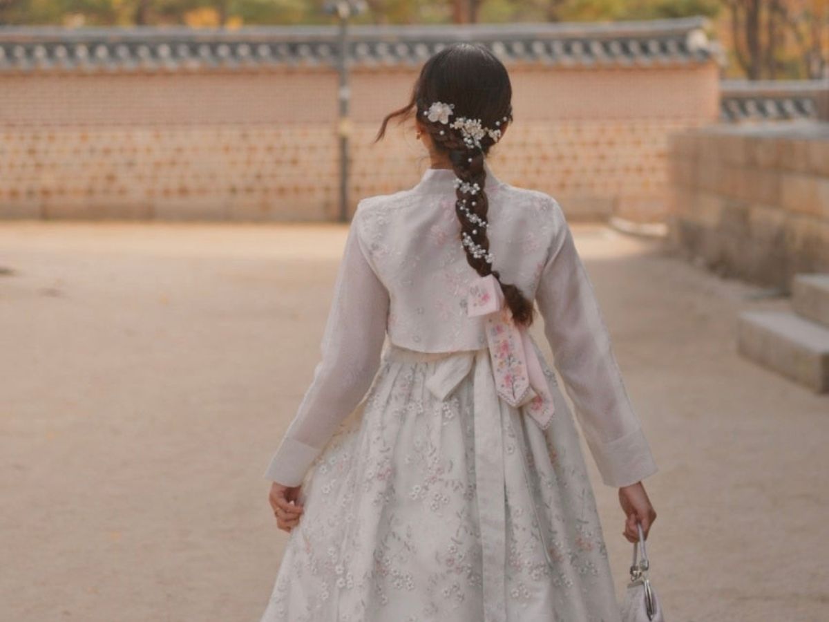A simple plait down the back becomes something special when you weave in floral pins or pearl clips along the length. (Ria Amin)