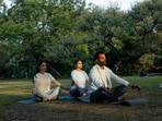 “Another powerful way to think about routines is to develop daily, weekly, and monthly practices.” Here, people have incorporated yoga into their daily lives. (Shutterstock)