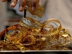 A goldsmith weighs gold jewellery inside a showroom in Ahmedabad, India.
