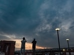 Gram it: People pause to capture cloud-laden skies as a pleasant evening unfolds at Bharat Mandapam.