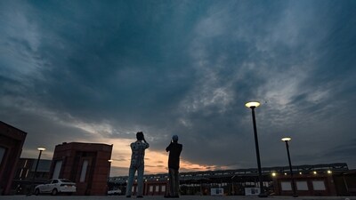 Gram it: People pause to capture cloud-laden skies as a pleasant evening unfolds at Bharat Mandapam. (Photo: Raj K Raj / HT)