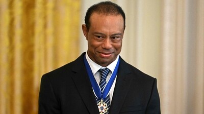 Tiger Woods looks on as unseen US President Donald Trump speaks during a reception for Black History Month (AFP) Tiger Woods looks on as unseen US President Donald Trump speaks during a reception for Black History Month (AFP)