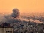 A plume of smoke rises following a US-Israeli military strike in Tehran, Iran.