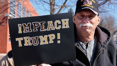 A man holds a sign reading "Impeach Trump" as he takes part in the "No Kings" national day of protest in Howell, Michigan, on March 28, 2026. (AFP) A man holds a sign reading "Impeach Trump" as he takes part in the "No Kings" national day of protest in Howell, Michigan, on March 28, 2026. (AFP)