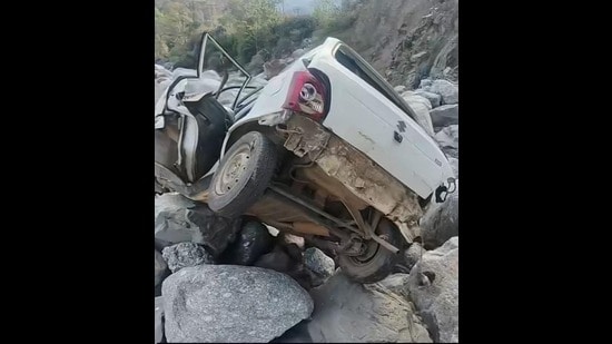 The car that fell into gorge in Himachal’s Kangra on Saturday. (HT Photo)