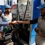 Malik Mohsin Ali, a rider for Bykea, ride-hailing and delivery platform, pays for fuel at a petrol station in Karachi, Pakistan, March 18, 2026. REUTERS/Asim Hafeez