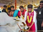 Telangana CM A Revanth Reddy offers food to a cow at a temple at the foundation-laying event in Manchirevula on Saturday. (ANI) Telangana CM A Revanth Reddy offers food to a cow at a temple at the foundation-laying event in Manchirevula on Saturday. (ANI)