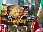 Demonstrators hold up an image of  Reza Pahlavi, son of the last shah of Iran, and US President Donald Trump as they rally in support of Iranians' fight for freedom, on the National Mall in Washington, DC, on March 29, 2026. 