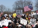 A person holds a sign reading "ICE out now" as they rally at Grant Park during the "No Kings" national day of protest in Chicago on March 28, 2026. (Photo by KAMIL KRZACZYNSKI / AFP)