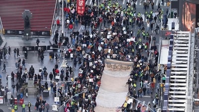 Protesters holding a large sign depicting the Declaration of Independence march near Times Square during the "No Kings" national day of protest in New York on March 28, 2026. (Photo by CHARLY TRIBALLEAU / AFP) (AFP) Protesters holding a large sign depicting the Declaration of Independence march near Times Square during the "No Kings" national day of protest in New York on March 28, 2026. (Photo by CHARLY TRIBALLEAU / AFP) (AFP)